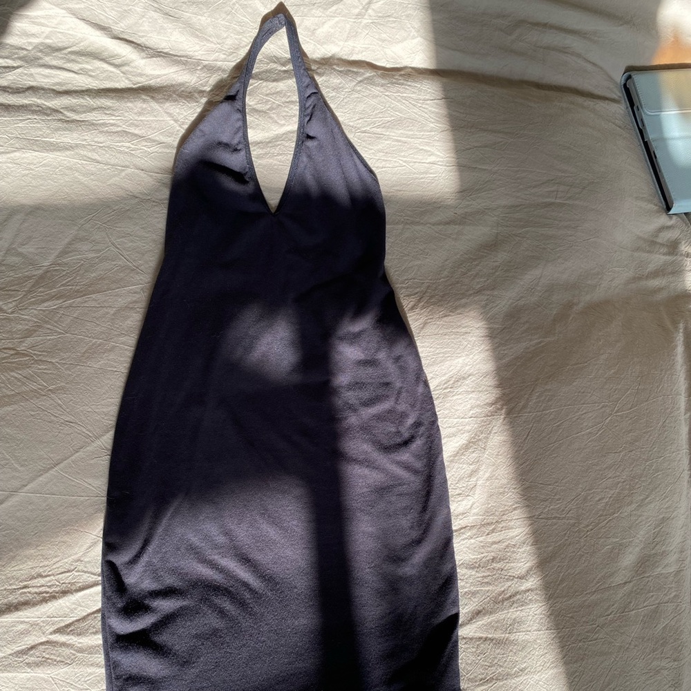 Fitted black dress with halter top and low v back.